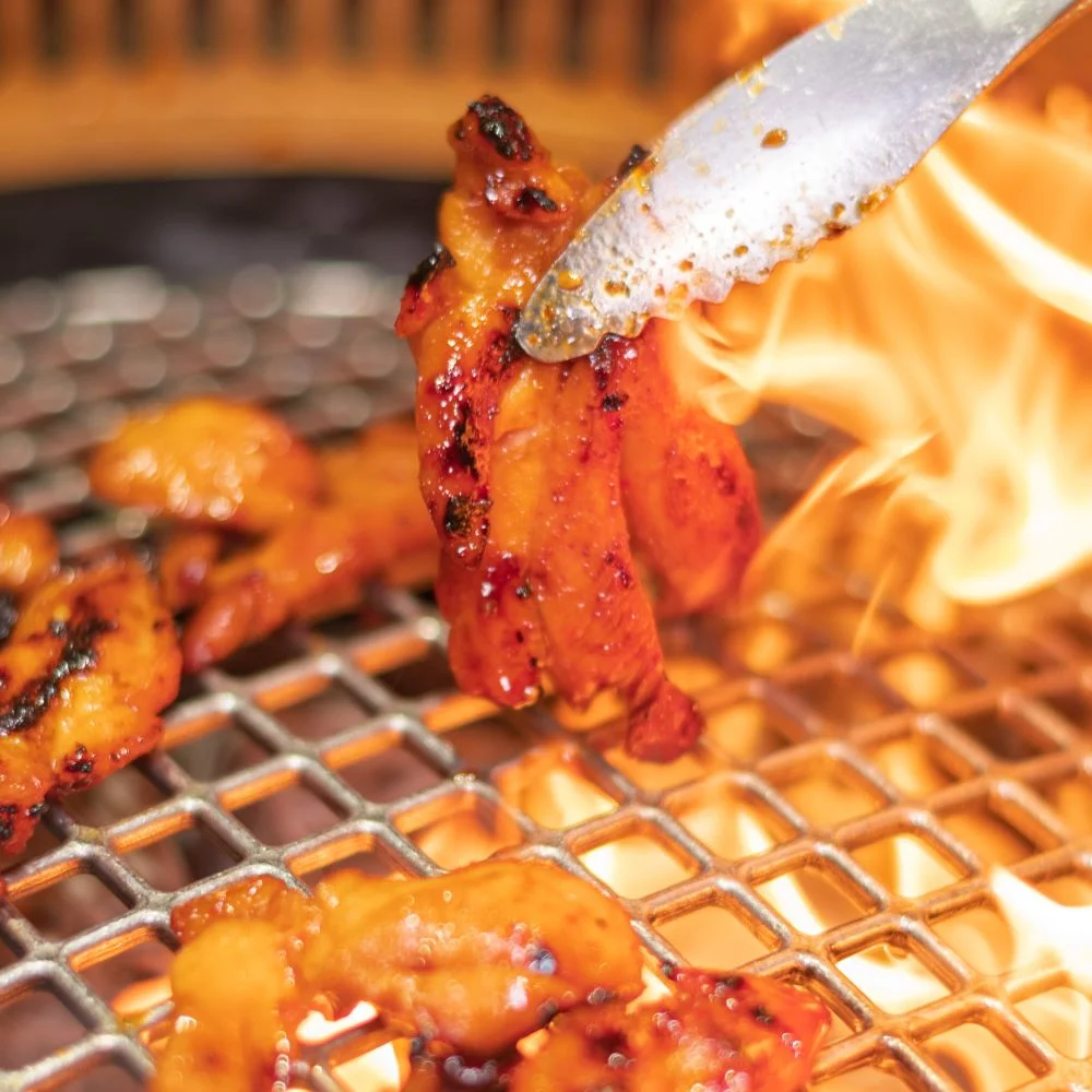 炭火の網の上で和牛を焼き上げる様子